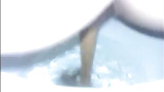 Girl shitting diarrhea in the toilet closeup