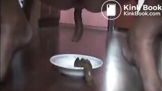Woman shitting long turd on a plate