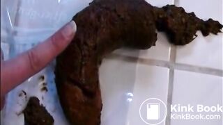 Woman shitting a long hard turd