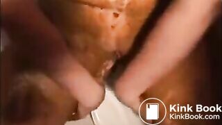 Woman shitting and smearing shit on her body
