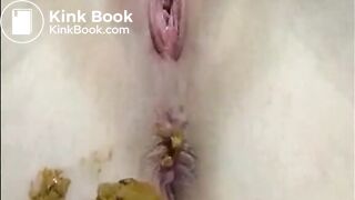Shaved girl shitting closeup and fingering her pussy