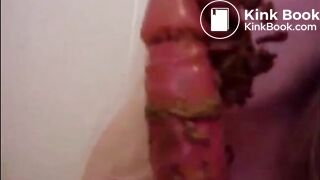 Dirty girl sucking and licking a shitty dildo