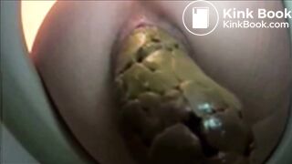 Woman shitting a very big turd