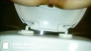 Woman shitting a long turd Closeup