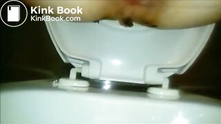 Woman shitting a long turd Closeup