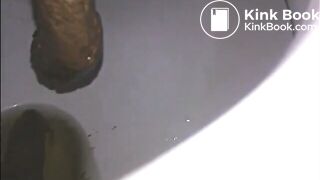 Woman shitting a long turd very slowly in the toilet