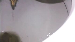 Woman shitting a long turd very slowly in the toilet