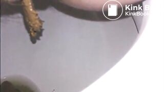 Woman shitting a long turd very slowly in the toilet