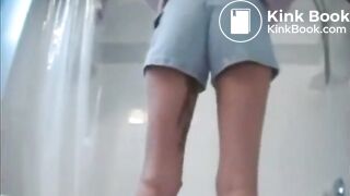 Poop in shorts runs down her leg
