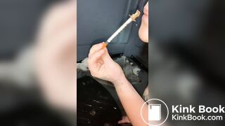 Syringe covered in shit for worthless human toilet