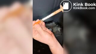 Syringe covered in shit for worthless human toilet
