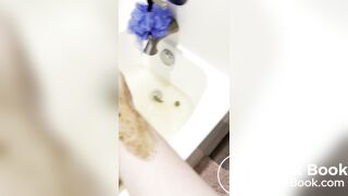 Smelly gal scoops her poop from the shower water