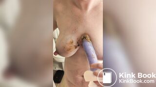 Nervously smearing her dirty dildo on her tits