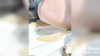 A plump buttock defecating on the toilet.