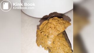 shitting out a big turd onto the floor