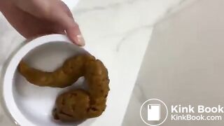 Filling a bowl for the dog with a big poo..