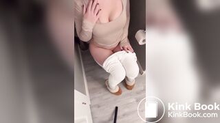 Sexy girl in white leggings having diarrhea on toilet