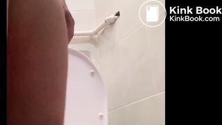 woman pooping outside toilet.