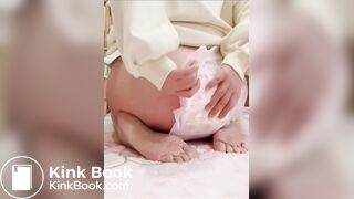 Chinese girl messes and sits in diaper