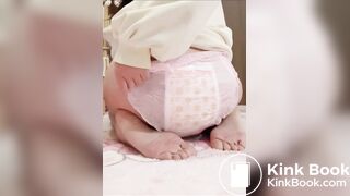 Chinese girl messes and sits in diaper