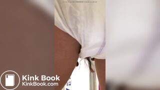 Girl pooping in her diaper.