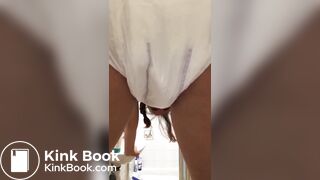 Girl pooping in her diaper.