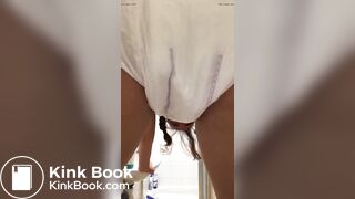 Girl pooping in her diaper.