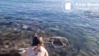 girl shitting her bathing suit at the beach