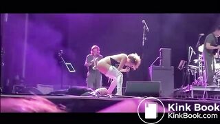 singer pisses on fan on stage.