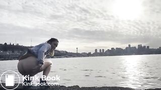 girl shitting in a lake shore