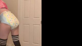 Cute girl poops diaper in front of door