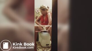 Girl in a red dress pissing at a party