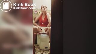 Girl in a red dress pissing at a party