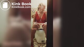 Girl in a red dress pissing at a party