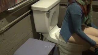 Redhead girl uses toilet