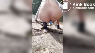 Girl shits outdoors on a hiking trip
