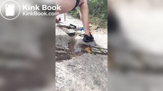 Girl shits outdoors on a hiking trip
