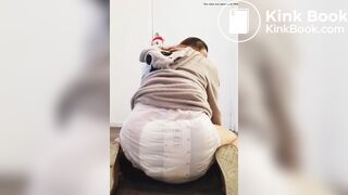 Girl sits and squishes in her poopy diaper