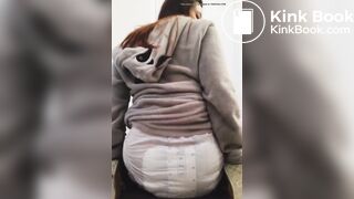 Girl sits and squishes in her poopy diaper