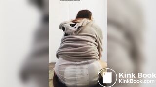 Girl sits and squishes in her poopy diaper