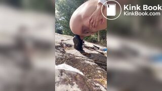 Cute girl outdoor shitting on the rocks