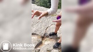Cute girl outdoor shitting on the rocks
