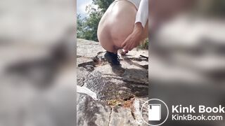 Cute girl outdoor shitting on the rocks