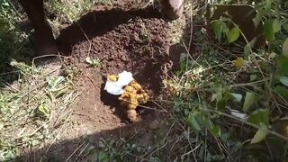 African lady carrying a poo to its grave..