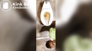 Two women shitting in public toilet