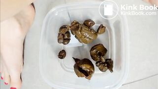 girl shits stone like turds in a container