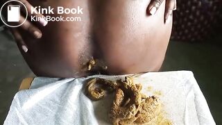 African lady poops on her sewing at a warehouse..