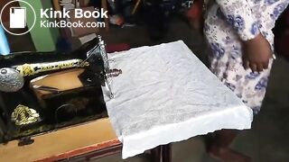 African lady poops on her sewing at a warehouse..