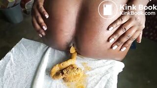 African lady poops on her sewing at a warehouse..