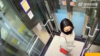 Asian woman shitting in an elevator